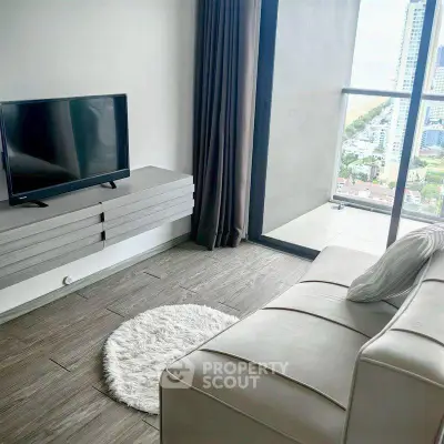 Modern living room with sleek furniture and city view from balcony.
