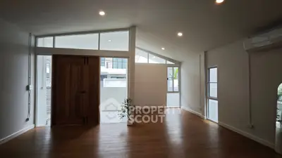 Spacious modern living room with high ceilings and large windows
