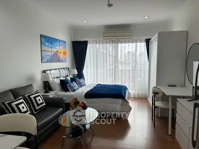 Modern studio apartment with stylish decor and city view.