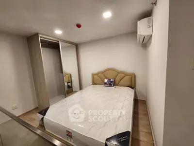 Cozy bedroom with modern design, featuring a comfortable bed and built-in wardrobe, perfect for restful nights.