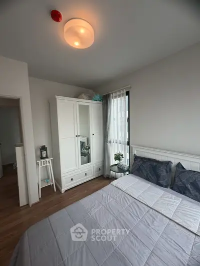 Cozy bedroom with modern white furniture and natural light