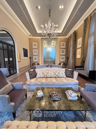 Luxurious living room with elegant chandelier and plush seating in a sophisticated setting.