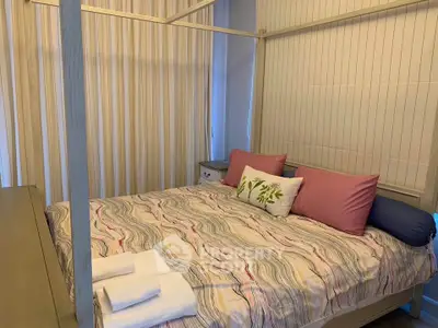 Cozy bedroom with stylish bedding and soft lighting, perfect for relaxation.