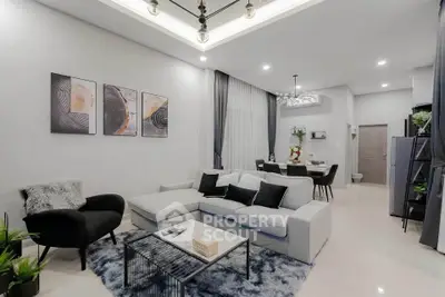 Modern living room with stylish decor and open layout, featuring cozy seating and elegant lighting.