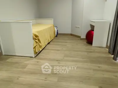 Cozy bedroom with wooden flooring and modern furniture, perfect for a comfortable living space.