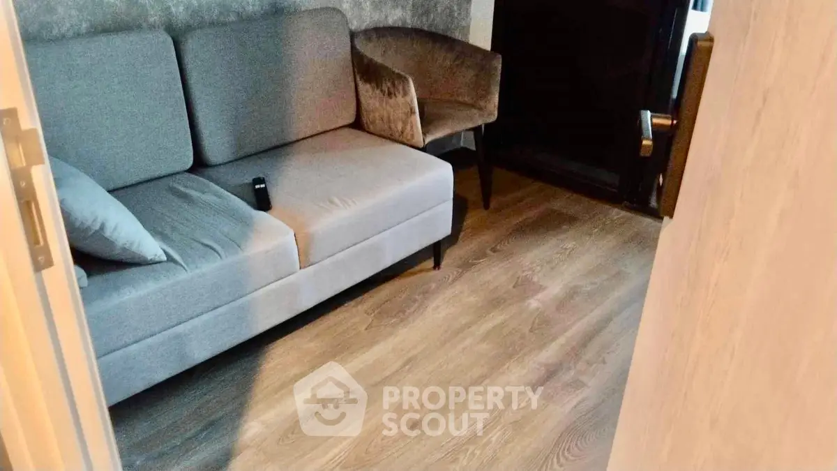 Cozy living room with modern gray sofa and wooden flooring