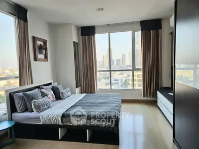 Spacious bedroom with city view and modern decor in high-rise apartment