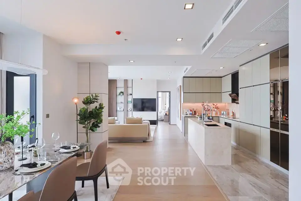 Luxurious open-plan living and dining area with modern kitchen in a spacious apartment.