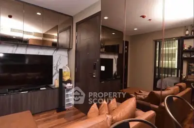 Modern living room with leather sofas, large TV, and mirrored cabinets for a spacious feel.