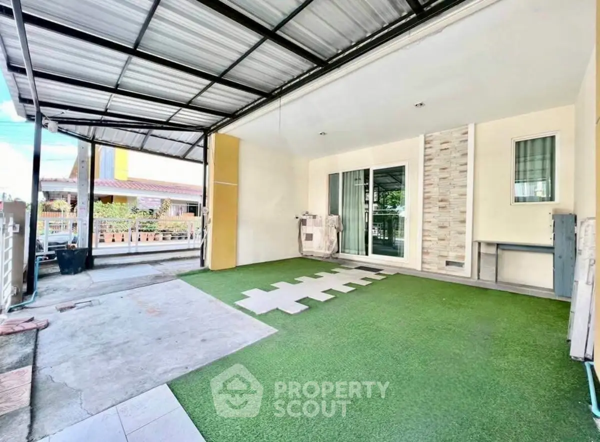 Spacious covered patio with artificial grass and modern design