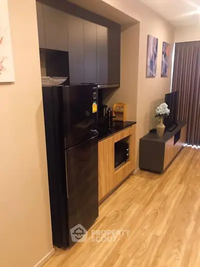 Modern living room with sleek kitchen area and stylish decor