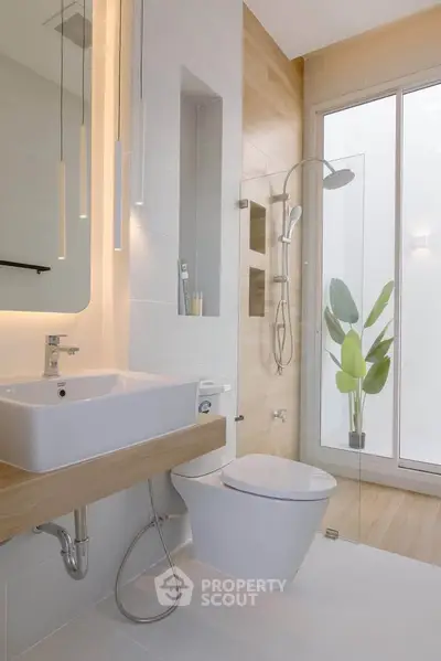 Modern bathroom with sleek fixtures and glass shower enclosure