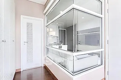Modern interior with glass partition and sleek design, showcasing a stylish and functional living space.