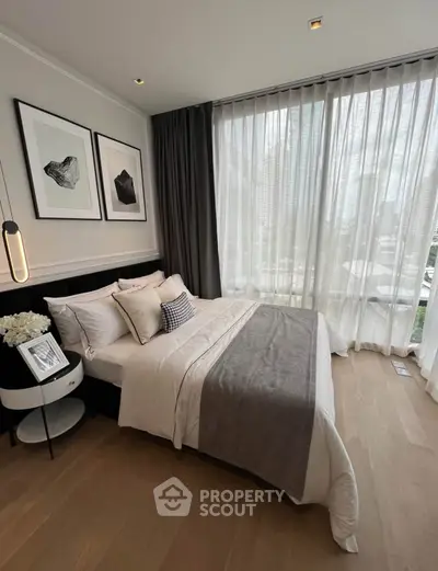 Elegant bedroom with floor-to-ceiling windows and modern decor in a luxury apartment.