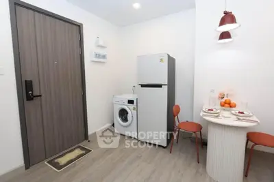 Cozy apartment corner with fridge, washing machine, and dining setup