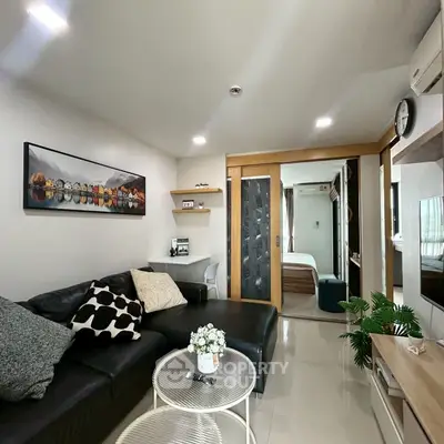 Modern living room with sleek black sofa and stylish decor