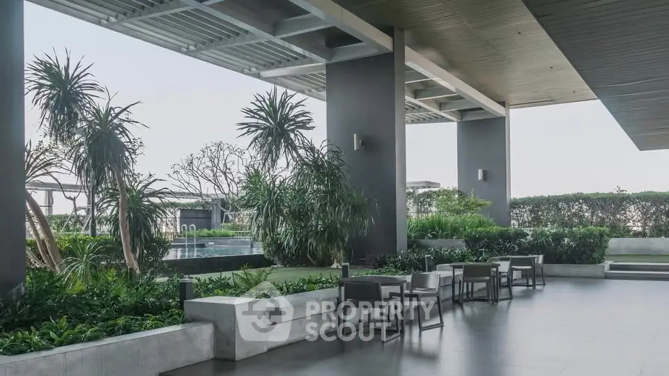 Luxurious outdoor seating area with lush greenery and modern design, perfect for relaxation and social gatherings.