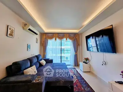 Spacious living room with modern decor and large TV, featuring elegant curtains and a cozy sectional sofa.