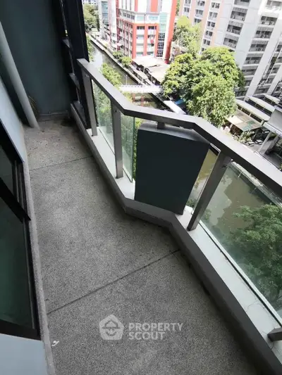 Spacious balcony with city view in modern apartment building