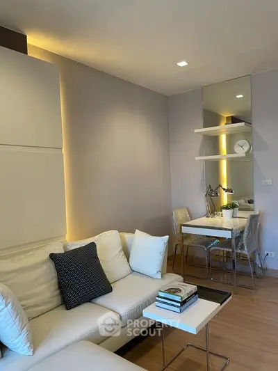 Modern living room with cozy white sofa and stylish dining area in a chic apartment.