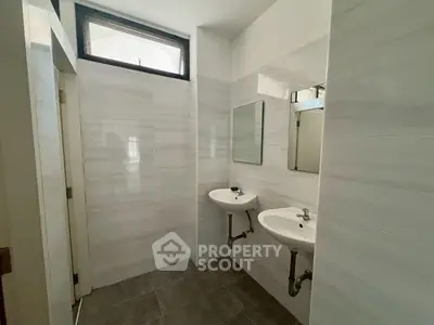 Modern bathroom with dual sinks and sleek tile design