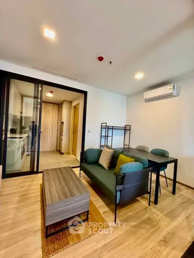 Modern living room with stylish furniture and open kitchen layout in a contemporary apartment.