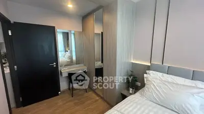 Modern bedroom with sleek design and cozy ambiance, featuring a stylish vanity and ample storage space.
