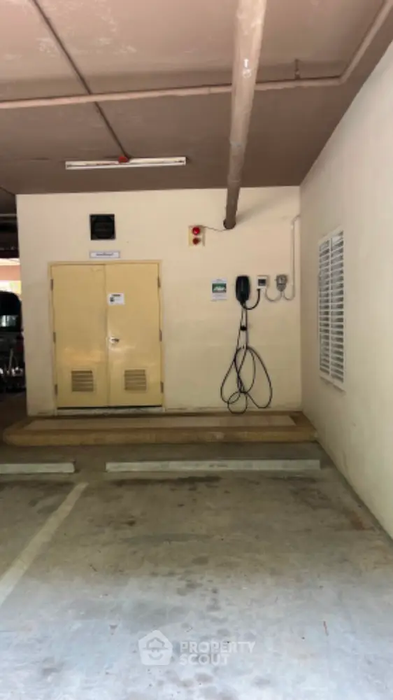 Secure parking space with electric vehicle charging station in modern building