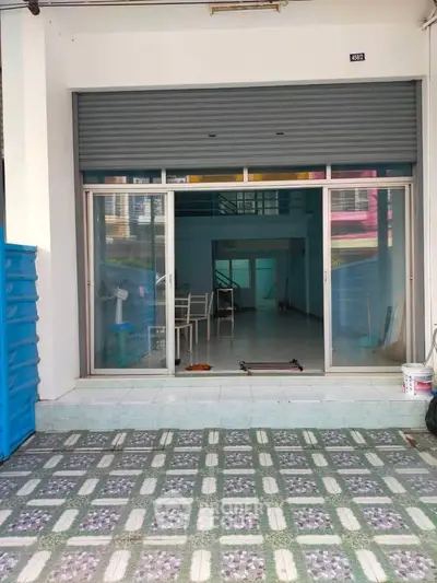 Spacious commercial property with glass facade and tiled entrance, ideal for business setup.