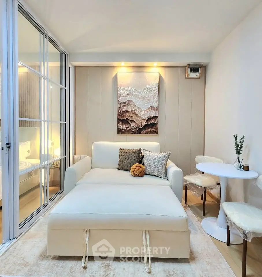Chic modern living room with cozy seating and elegant decor in a stylish apartment.