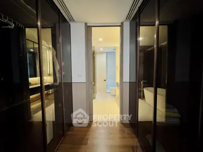 Luxurious hallway leading to a modern bathroom with elegant design and ambient lighting.