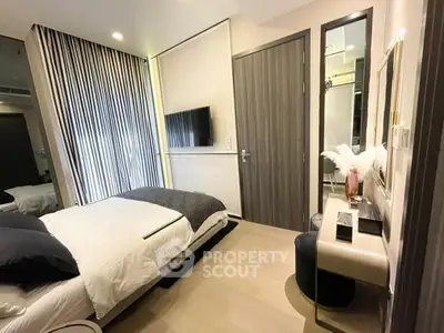 Modern bedroom with stylish decor and wall-mounted TV