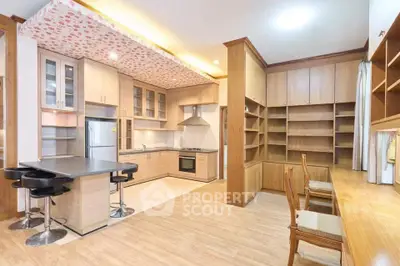 Spacious modern kitchen with island seating and ample storage in a stylish home.