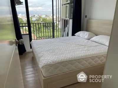 Cozy bedroom with balcony view in modern apartment