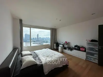 Spacious bedroom with stunning city skyline view and modern decor