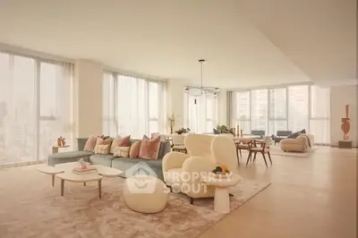Luxurious and spacious living room with modern furniture and large windows offering city views.