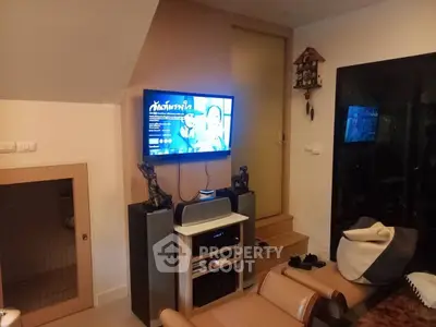 Cozy living room with TV and modern decor, perfect for relaxation and entertainment.