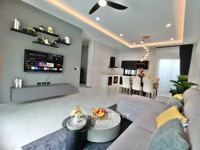 Modern open-concept living room with sleek decor and stylish kitchen area