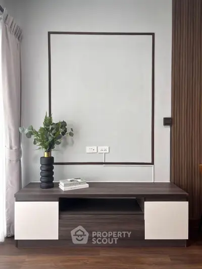 Modern living room with stylish wooden cabinet and elegant decor