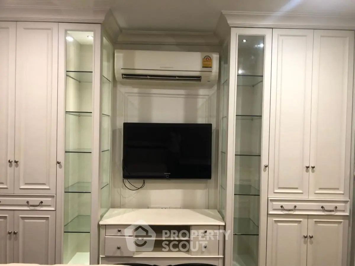 Elegant built-in storage with TV and air conditioning in modern living room