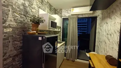 Chic urban kitchen with modern appliances and balcony access, perfect for city living.