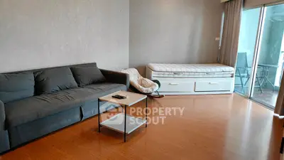 Spacious living room with modern sofa and balcony access