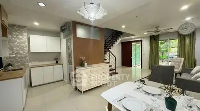 Modern open-plan living room with stylish decor and staircase