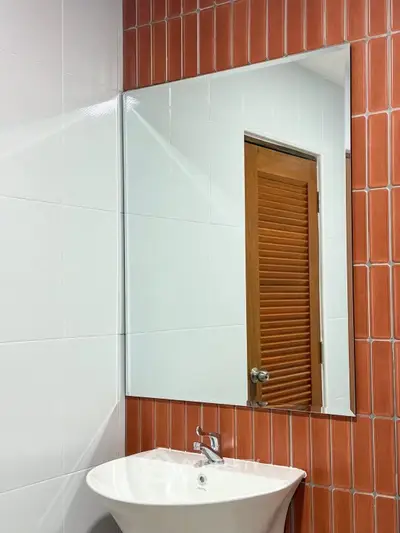 Modern bathroom with stylish red tiles and sleek white sink