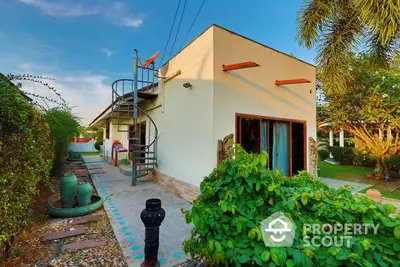 Charming single-story home with lush garden and unique spiral staircase