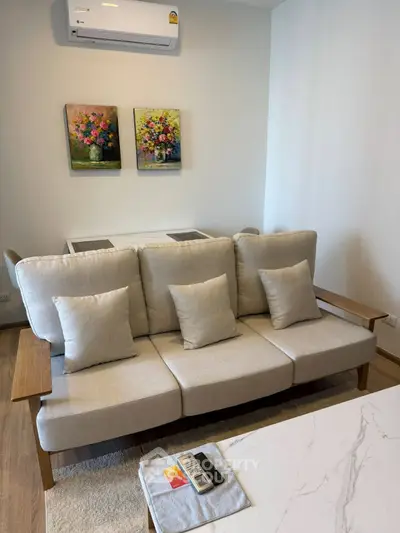 Modern living room with stylish sofa and air conditioning, perfect for comfort and relaxation.