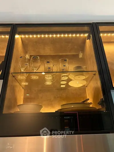 Modern kitchen cabinet with glass shelves and LED lighting