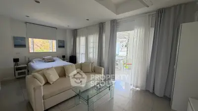 Spacious modern bedroom with large windows and balcony access, featuring elegant decor and natural light.