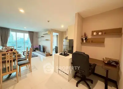Spacious open-plan living room with dining area and city view balcony.