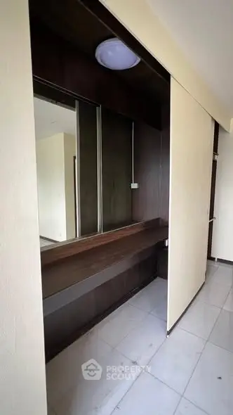 Modern interior with sleek wooden accents and built-in storage solutions.